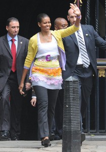 Michelle Obama waves to crowds of people waiting to catch a glimpse of the first lady during her trip to London. Photo: Jeremy Selwyn/Evening Standard/ZUMA Press - I mean...What?!